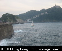 A sailboat entering the harbour.