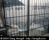 A gate blocking access to some steps. The writing says something in Basque I think.